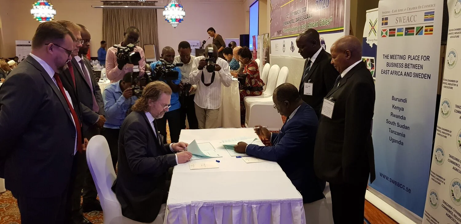 Swedish and East African representatives signing a partnership at a SWEACC gathering